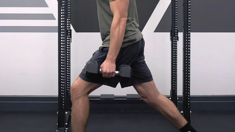A person performing the farmer's carry exercise.