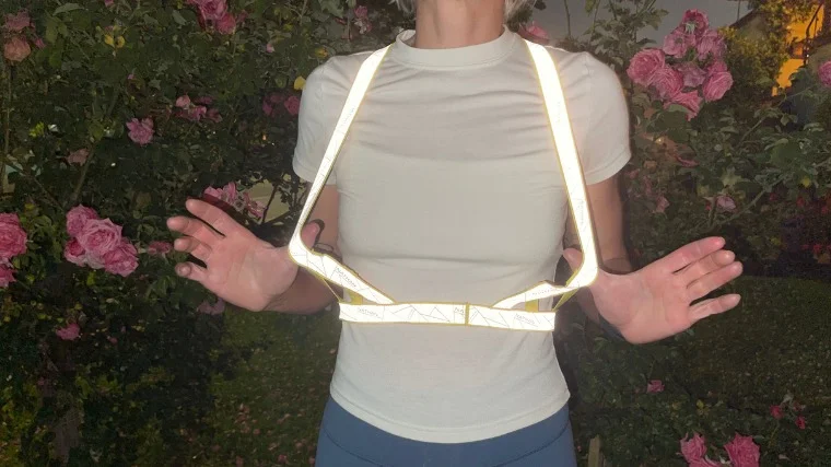 Our tester shows off the reflectivity of the Nathan Sports Vibe Reflective Vest.