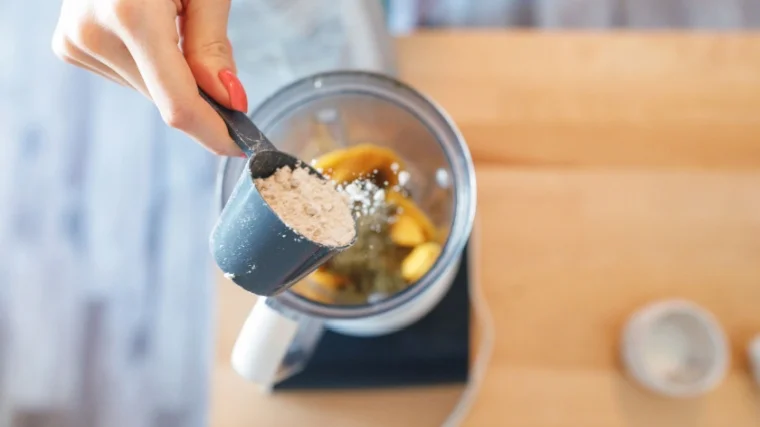 A person making a protein shake.