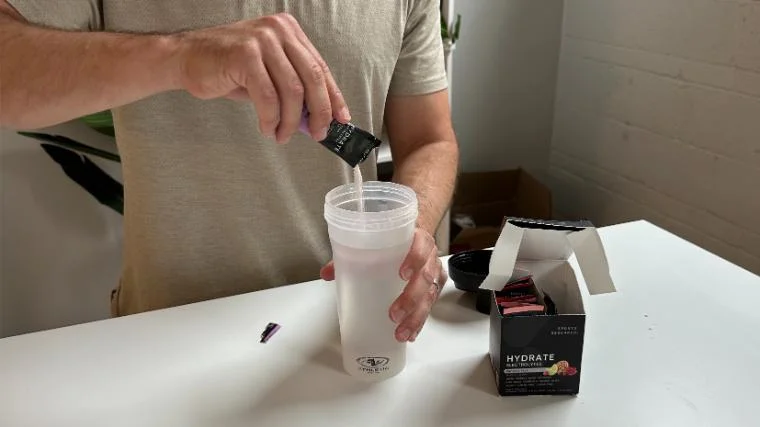 sports-research-hydrate-pouring-powder Our tester pouring Sports Research Hydrate into their shaker cup.