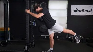 A person performing the glute kickback exercise.