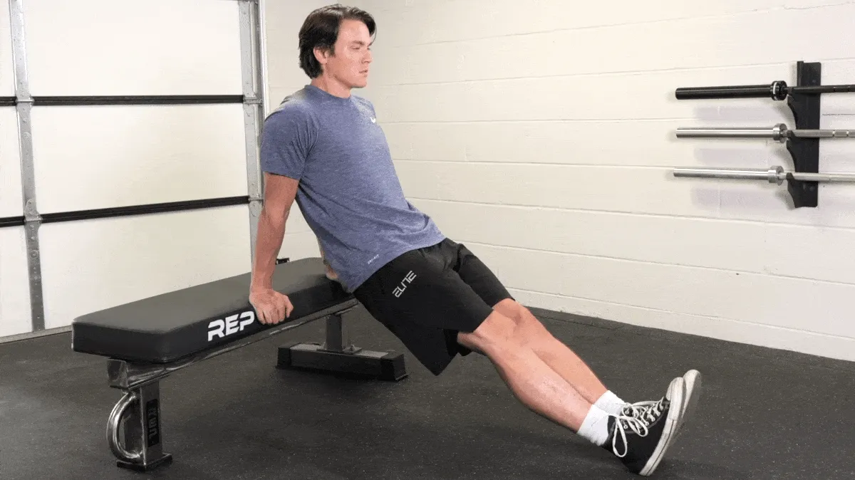 Jake performing the triceps dip with a weight bench.