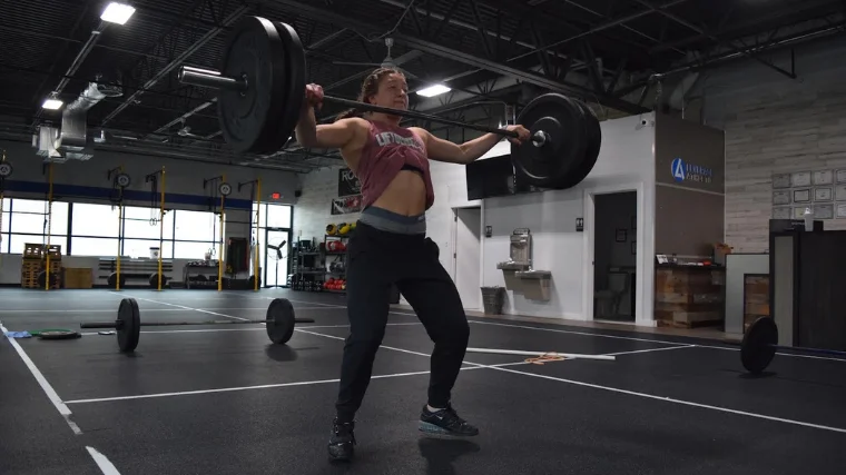 weightlifter pulls under barbell in snatch