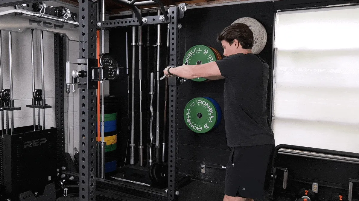 A person demonstrating the standing cable crossover flye movement.