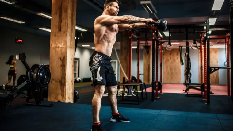 A person doing kettlebell swings.