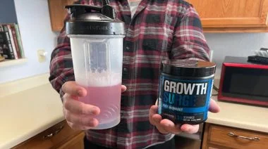 a man holding Jacked Factory Growth Surge