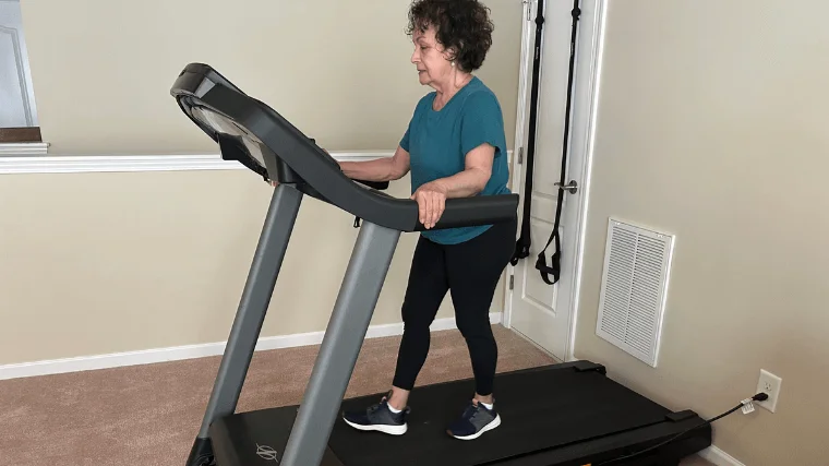 A person walks on the NordicTrack T-Series model.