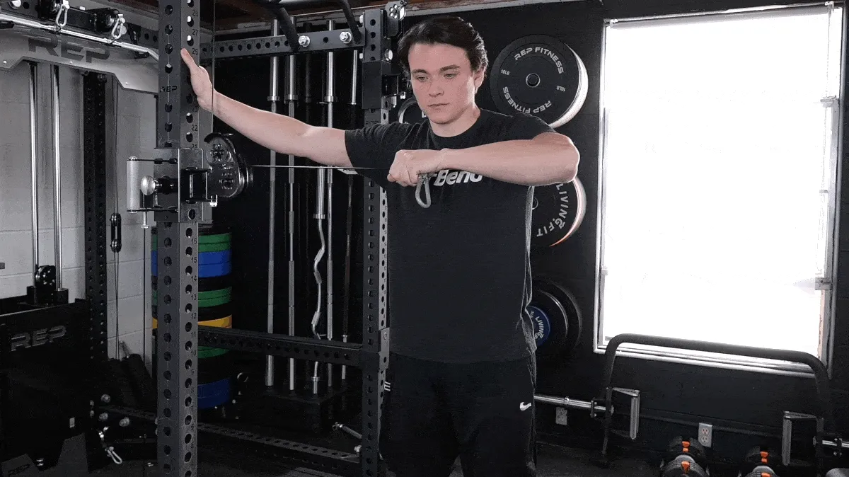 A person performing the single-arm cable cross-body tricep extension exercise.
