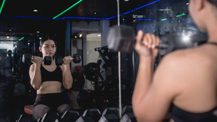 A person doing the Arnold press. 