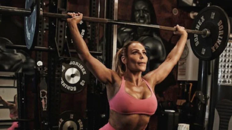 Natalya Neidhart performs a barbell overhead squat.