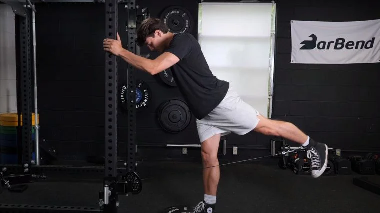 A person performing the glute kickback exercise.