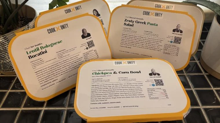 Various meals ordered from CookUnity displayed, still in their meal sleeves