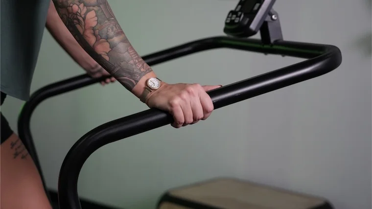bells-of-steel-motorless-treadmill-close-up-hands-on-handle-bar Our tester gripping the handrails of the Bells of Steel Wooden Residential Treadmill