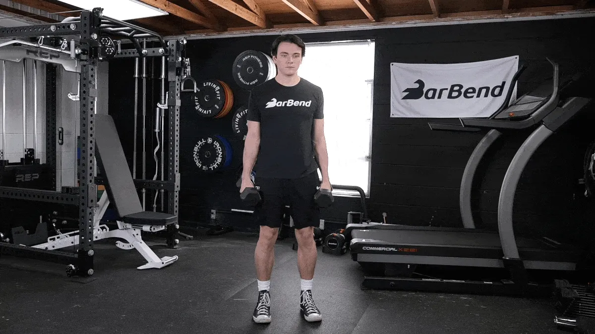 BarBend's Jake Herod performing the curtsy lunge exercise.