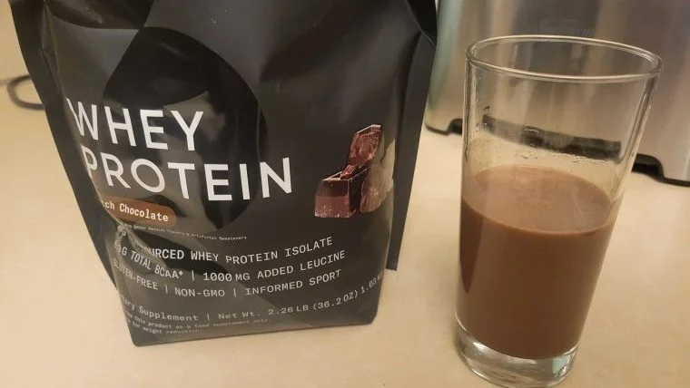 A bag of Sports Research Whey Protein Isolate with shake.