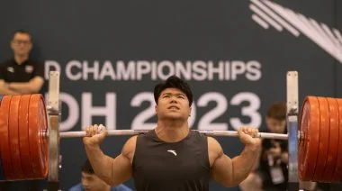A weightlifter squatting
