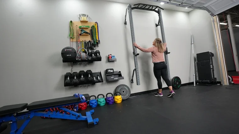 Our tester unfolding the PRx Performance Profile PRO folding squat rack.