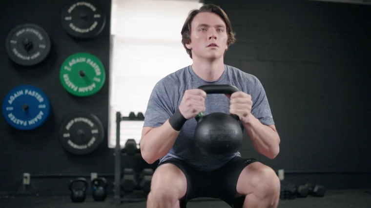 Jake Performing Goblet Squats with the Again Faster Kettlebell
