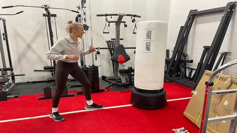 Our tester squaring up for a punch across FightCamp's free-standing punching bag