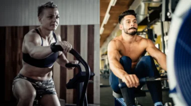 One person works out on an air bike while another works out on a rower.