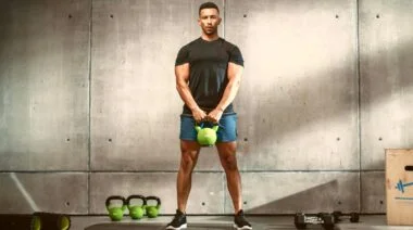 An athlete doing a kettlebell deadlift.