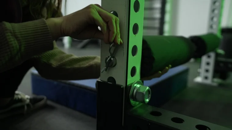 rep-fitness-leg-roller-attachment-putting-pin-in-end-of-roller Our tester attaches the REP Fitness Leg Roller Attachment with the cotter pin