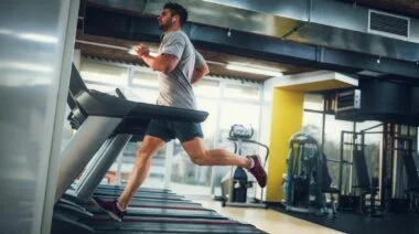 A gymgoer working out on a treadmill.