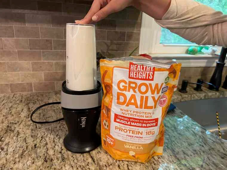 Mixing Healthy Heights Grow Daily in a blender.