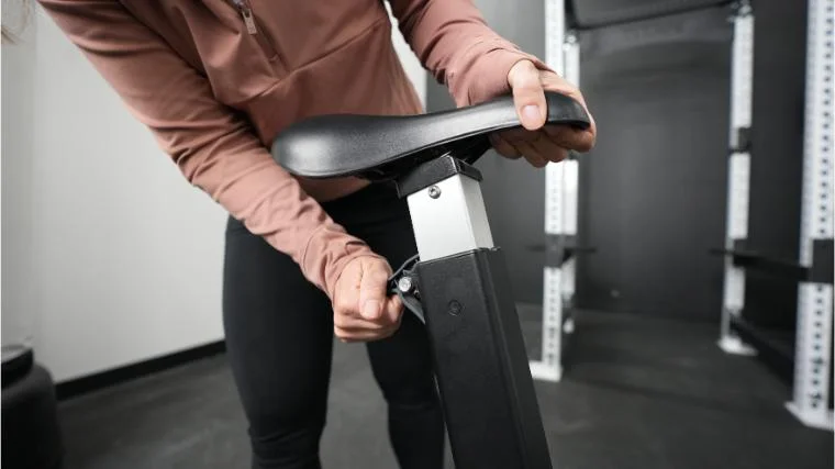 Our product tester adjusting the seat stack on the Concept2 BikeErg.