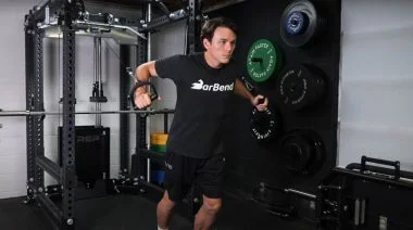 A person performing the cable chest flye exercise.