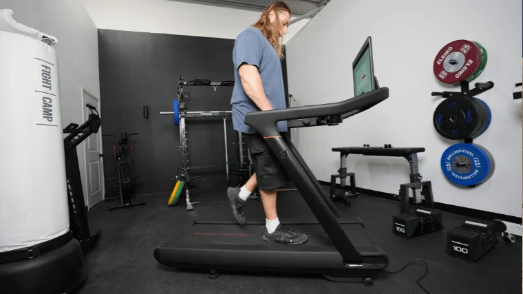 Our tester walks on the Peloton Tread.