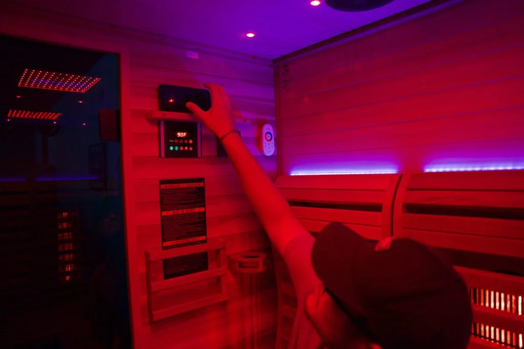Tester using control panel in Sun Home Luminar 5-Person Sauna
