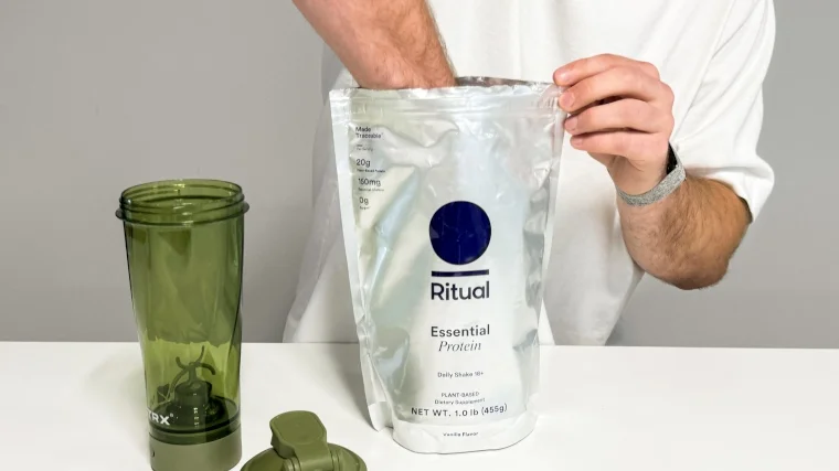 Our tester reaches deep into a bag of Ritual Essential Protein 18+ Protein Powder