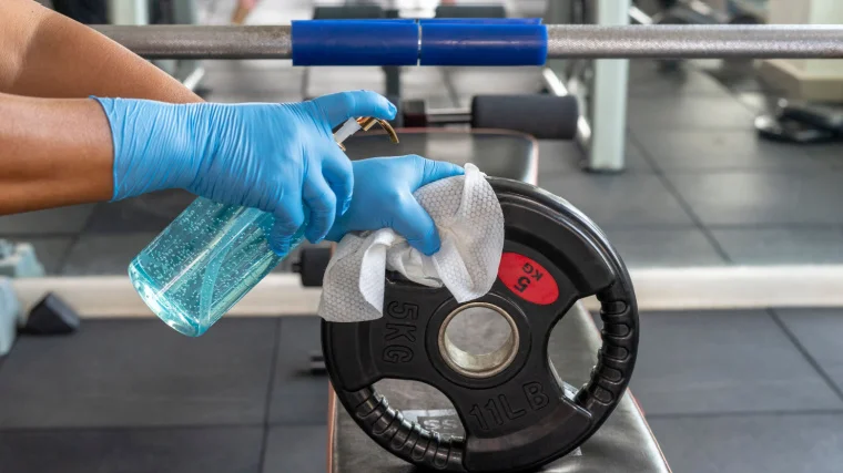 Spraying a weight plate.
