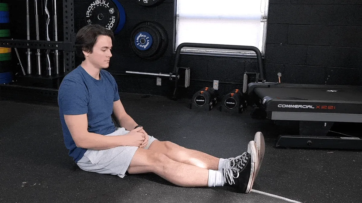 Jake doing the seated forward bend movement.