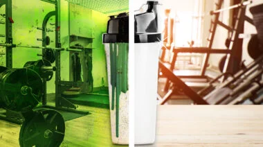 Protein shaker cup against gym background.
