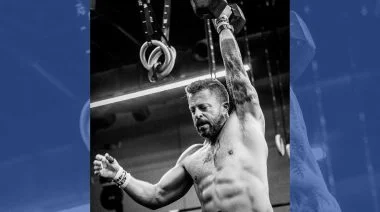 Jason Grubb hoisting a dumbbell in a semifinals competition.