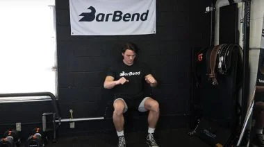 A person performing the wall sit exercise.