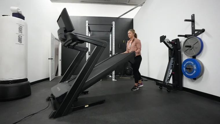 nordictrack-1750-2023-model-folding-unfolding-front-view Our tester unfolding the NordicTrack Commercial 1750 treadmill.