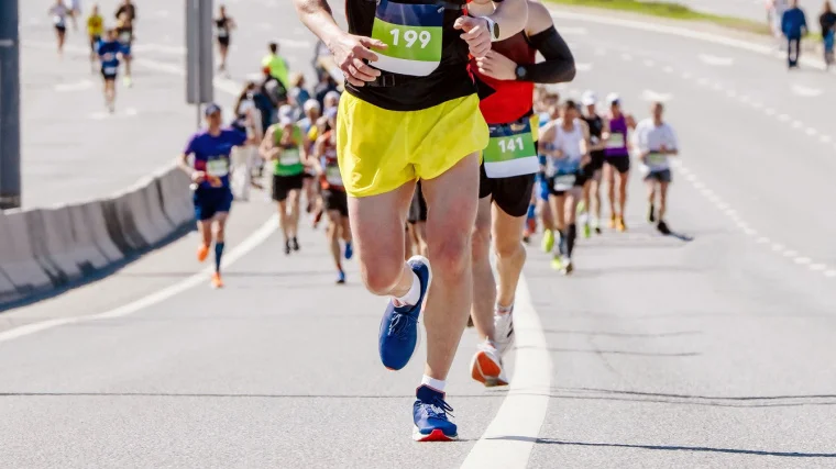 People running a marathon uphill.