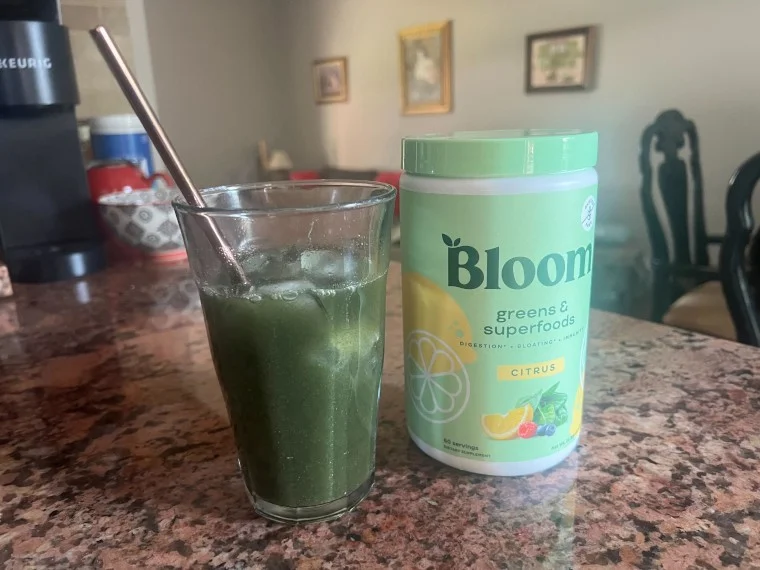 Bloom Greens in a cup by the container.