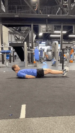 A person doing the lying leg raise.