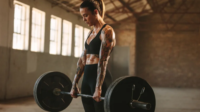 woman locking out deadlift