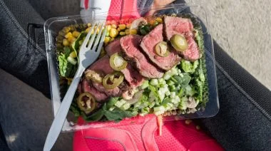 Food consisting of meat and vegetables in an open lunch box.