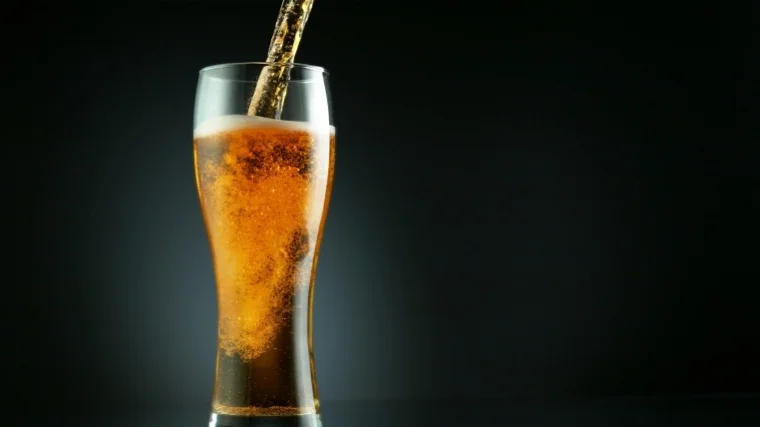 beer being poured into glass