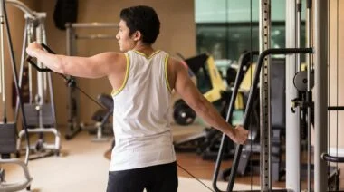 A person performing a lateral cable raise.