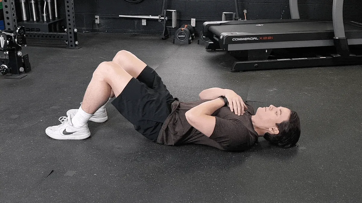 BarBend's Jake Herod doing partial curl-ups.