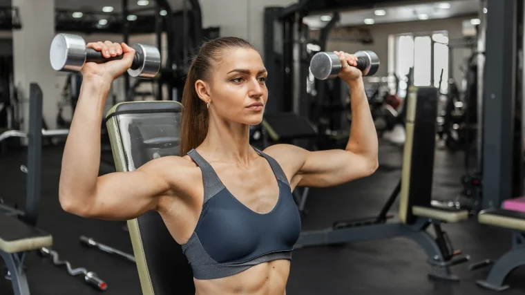 A person doing a seated shoulder press.