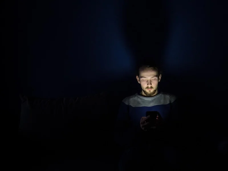 guy in bed with phone