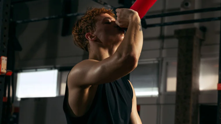 An athlete drinking a protein shake. 